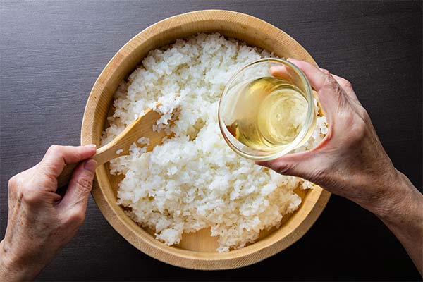 Wie man Reisessig zu gekochtem Reis hinzufügt